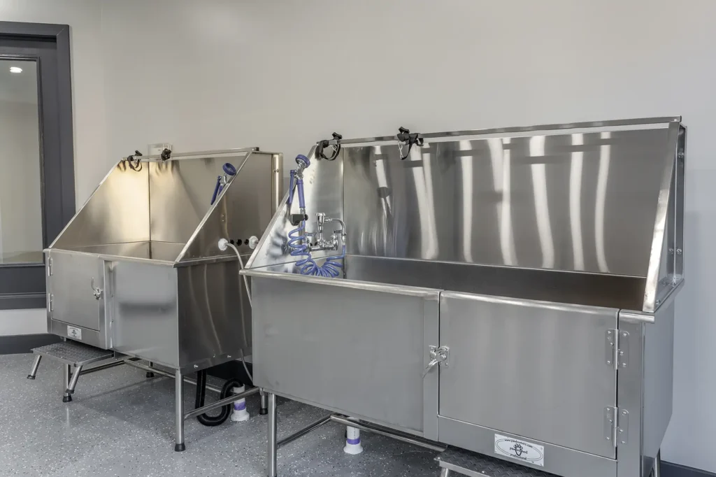 Pet wash station with large stainless steel tubs and hoses