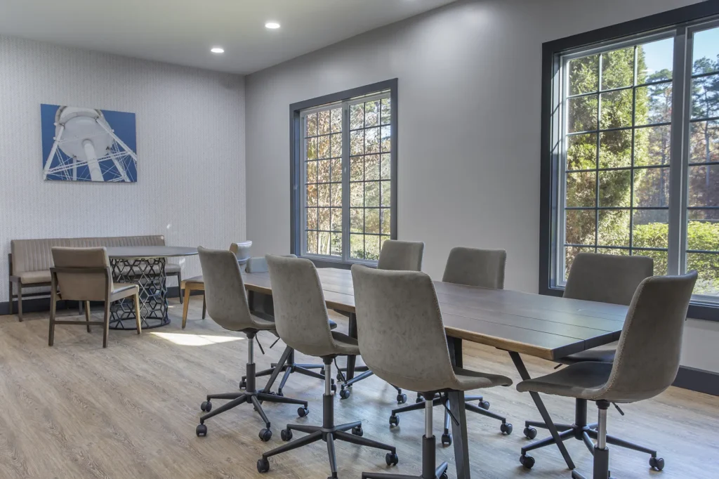 Conference room with large table and chairs, large windows