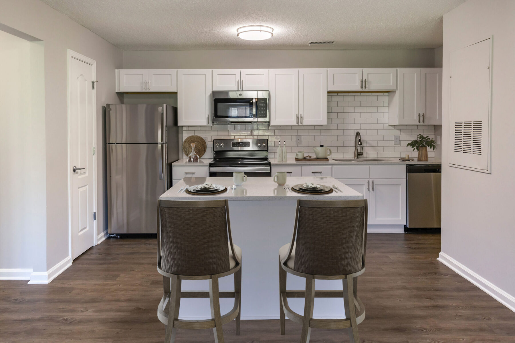 Open kitchen with stainless steel appliances and island seating
