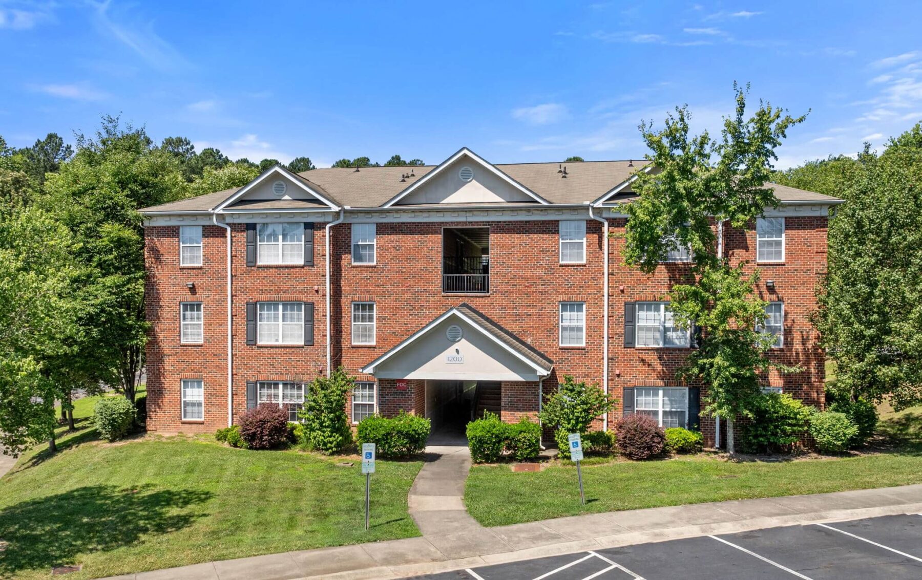Aerial view of exterior with surrounding garden landscaping and trees